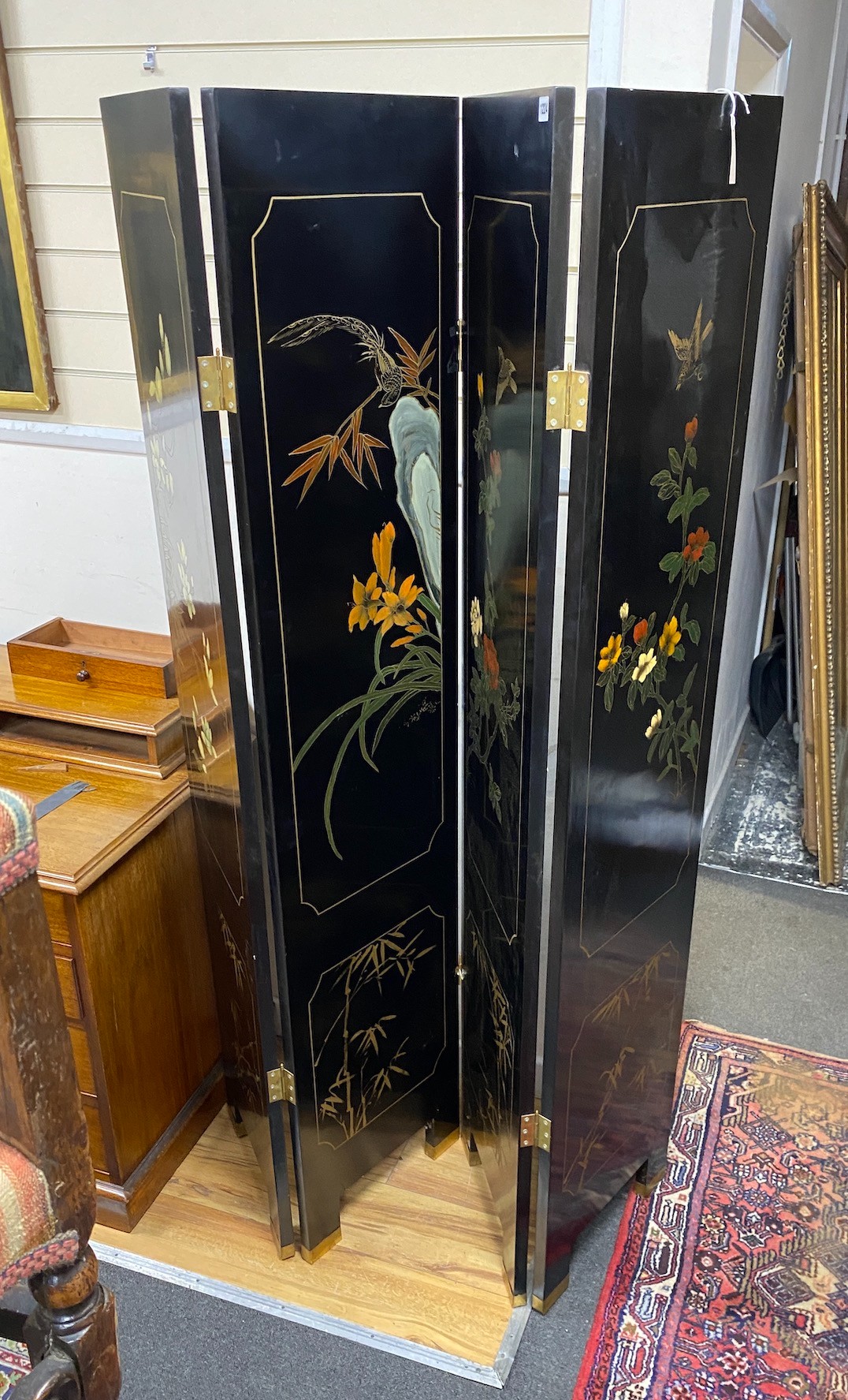 A Chinese lacquer four fold dressing screen, each panel width 40cm, height 184cm